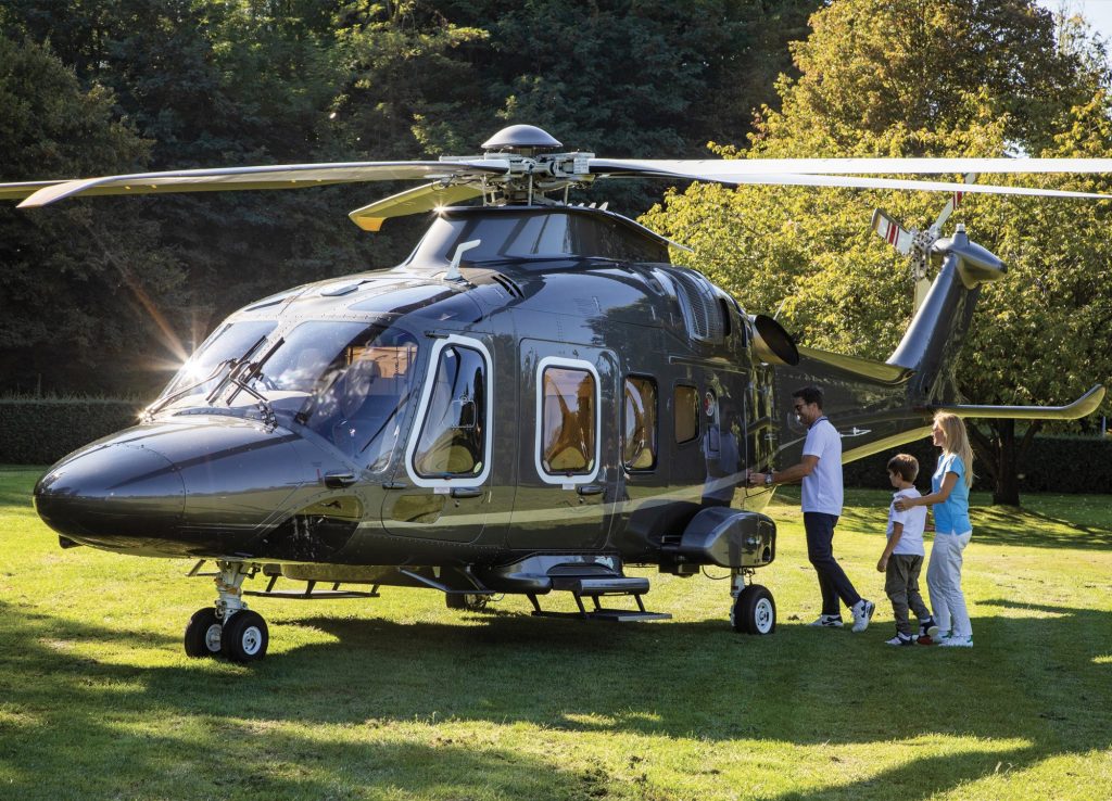 Family boarding a private helicopter charter (Agusta AW169) in Florida.